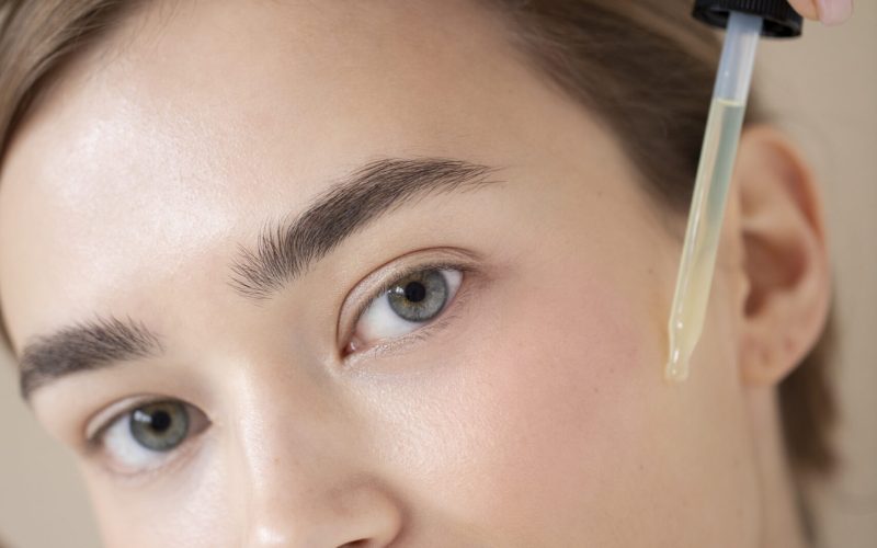 portrait-beautiful-woman-with-clear-skin-using-face-serum